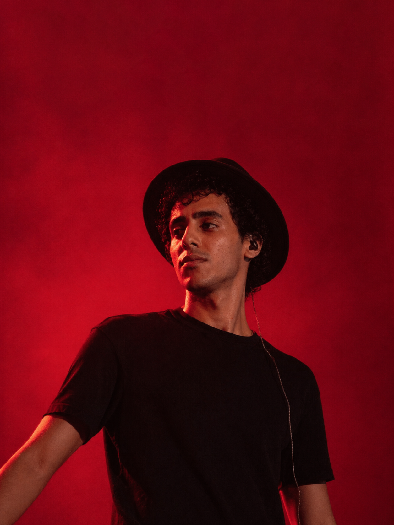 Abdallah Aboelmagd in red studio portrait.