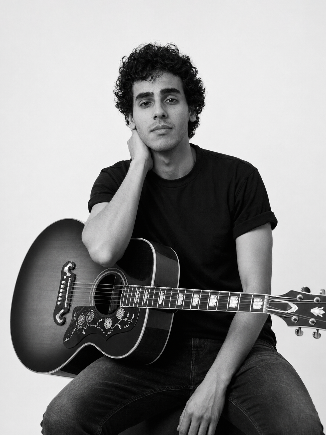 Abdallah Aboelmagd with acoustic guitar.